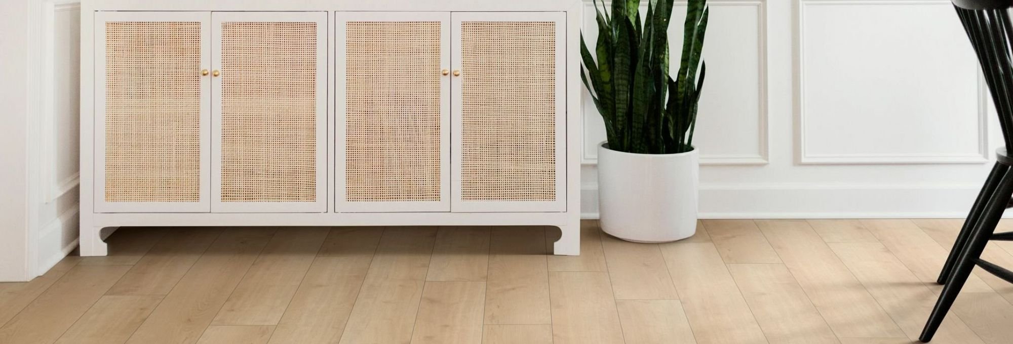 White cabinet on light brown laminate floor from Dishman Flooring on Houma, LA area