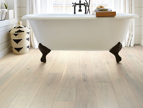 white standalone bathtub on laminate floors - Dishman Flooring Center