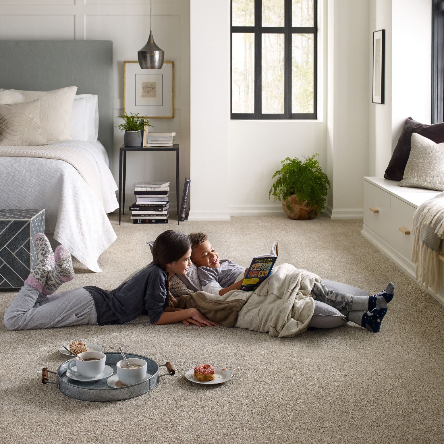 Kids reading on bedroom soft carpet from Dishman Flooring on Houma, LA area
